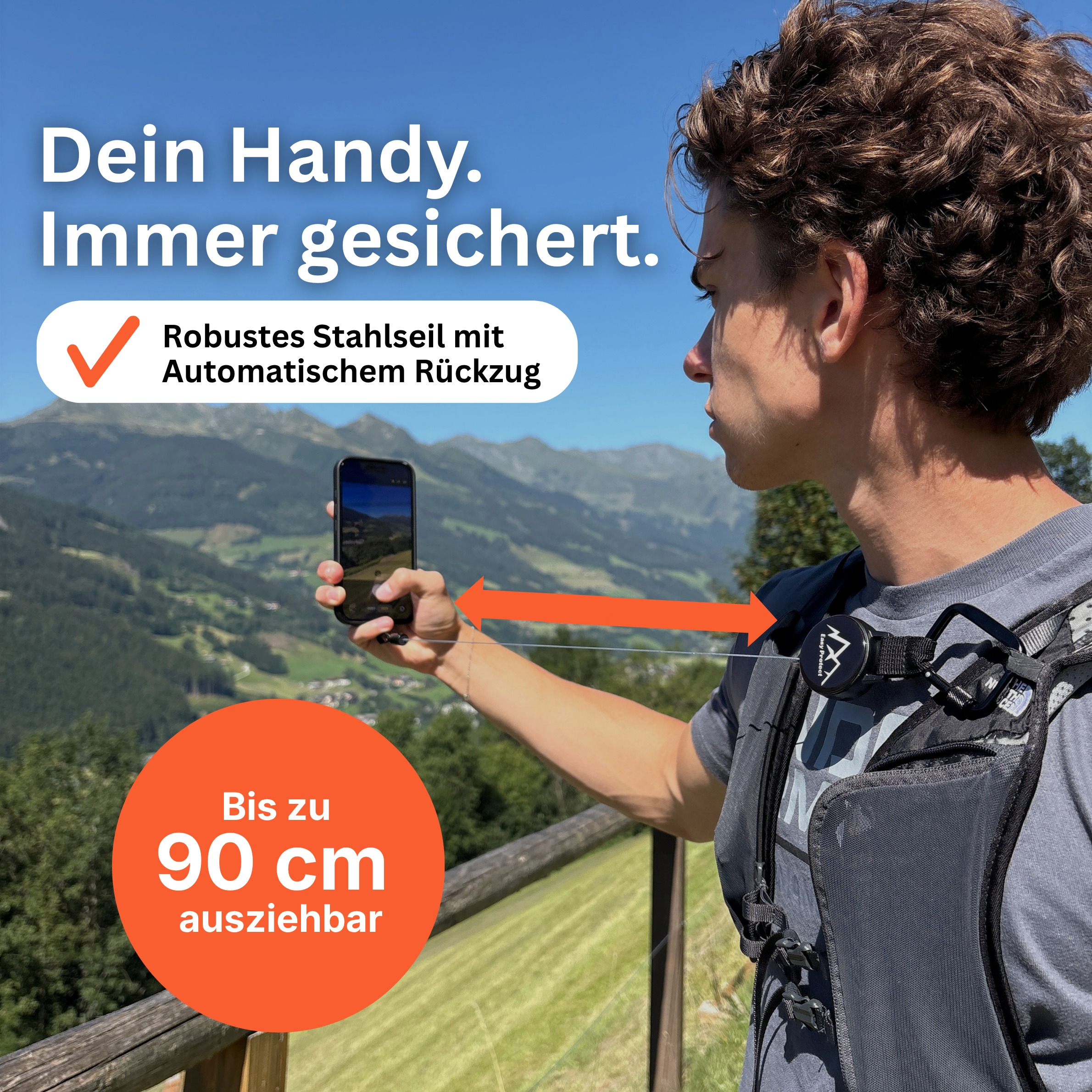 Easy Protect V3 Handysicherung am Rucksack eines Wanderers mit robustem, automatisch einziehbarem Stahlseil bis 90 cm.